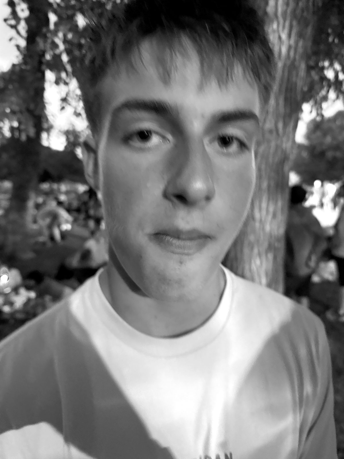 Henry, King and Founder of the Color Blind Club, photographed at dusk in a park, gazing steadily into a world he cannot color-correct.